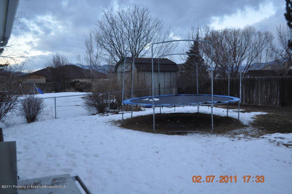 918 Edelweiss Court Rifle, CO 81650 - Photo 8 of 9 a view of a backyard with table and chairs with wooden fence