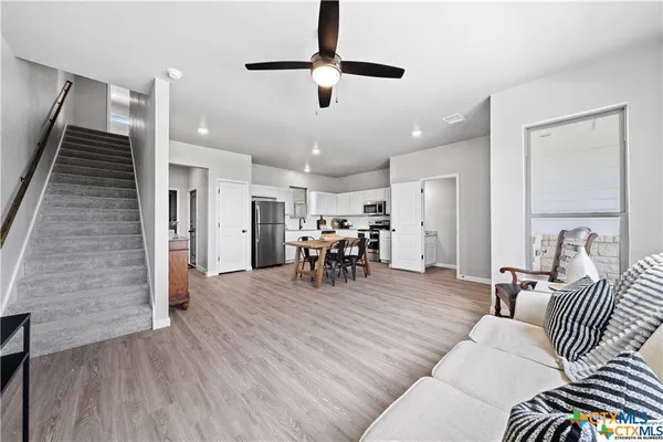 a living room with furniture and wooden floor