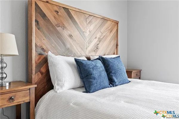 a large bed sitting in a bedroom next to a window