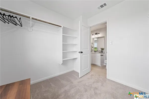 a view of a kitchen with white cabinets