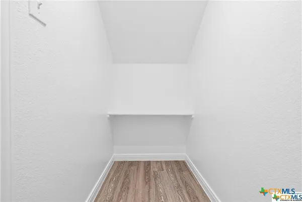 a view of room with wooden floor