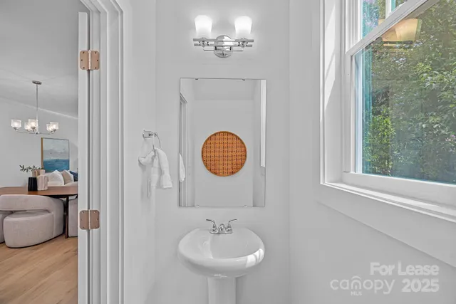 a bathroom with a sink a mirror and a window