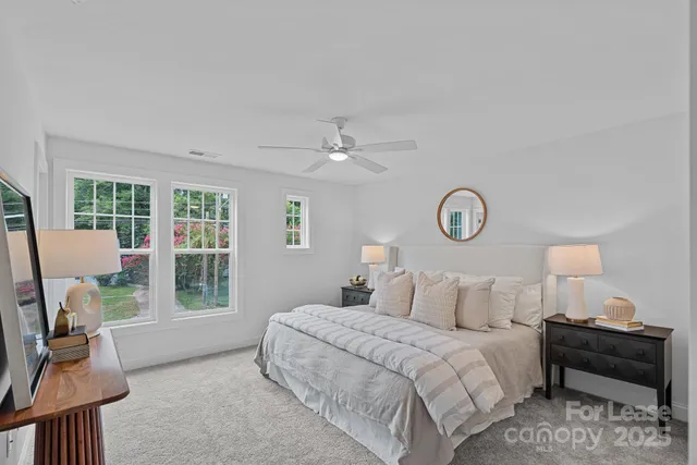 a bedroom with a large bed and a window