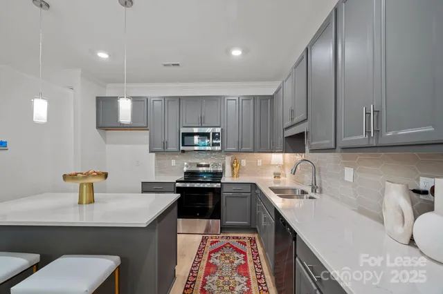 a kitchen with a sink a stove and cabinets