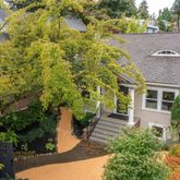 a aerial view of a house with a yard and potted plants