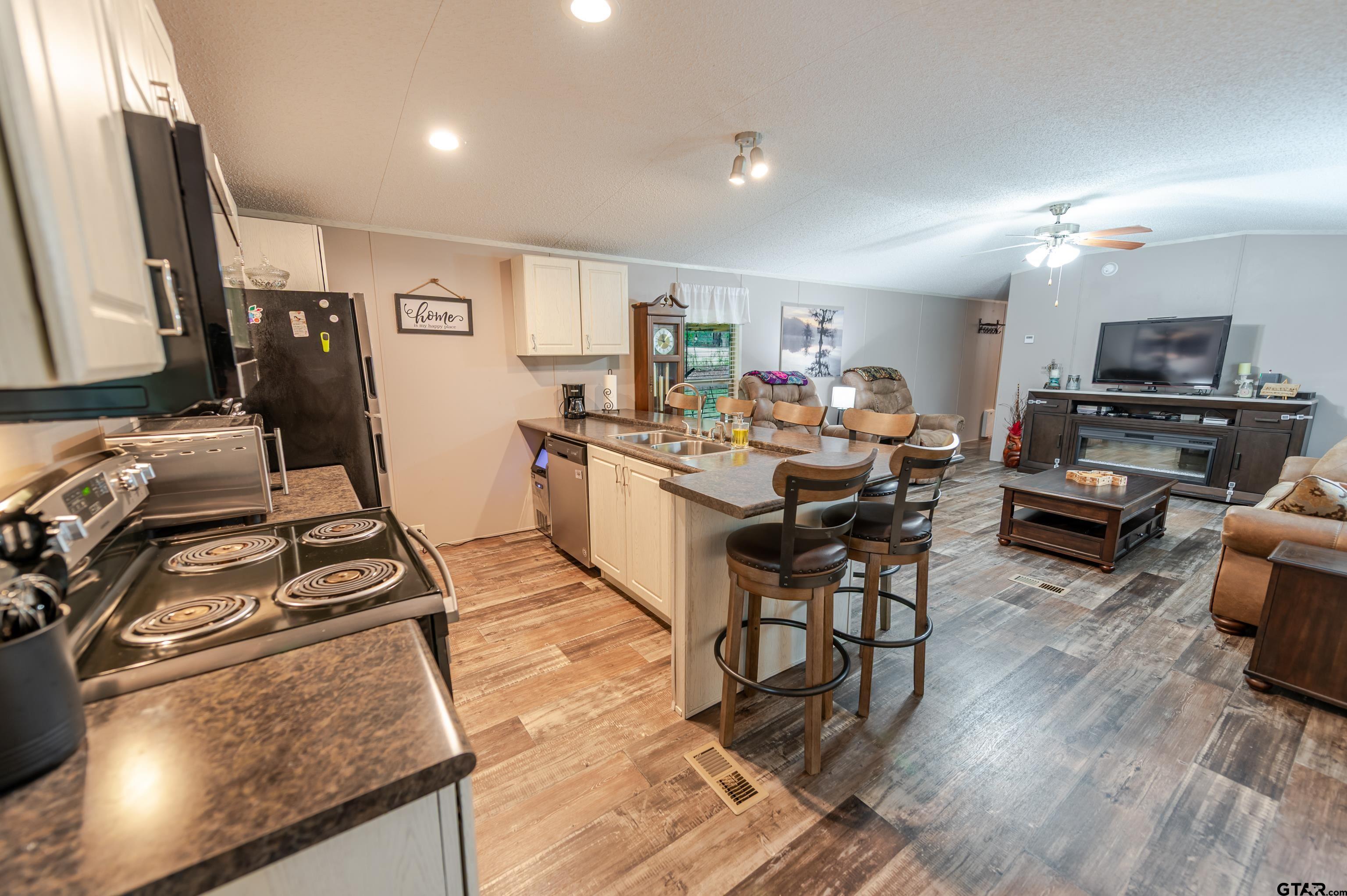 108 Sandy Brown Road Scroggins, TX 75480 - Photo 11 of 17 a kitchen with a sink appliances and wooden floor