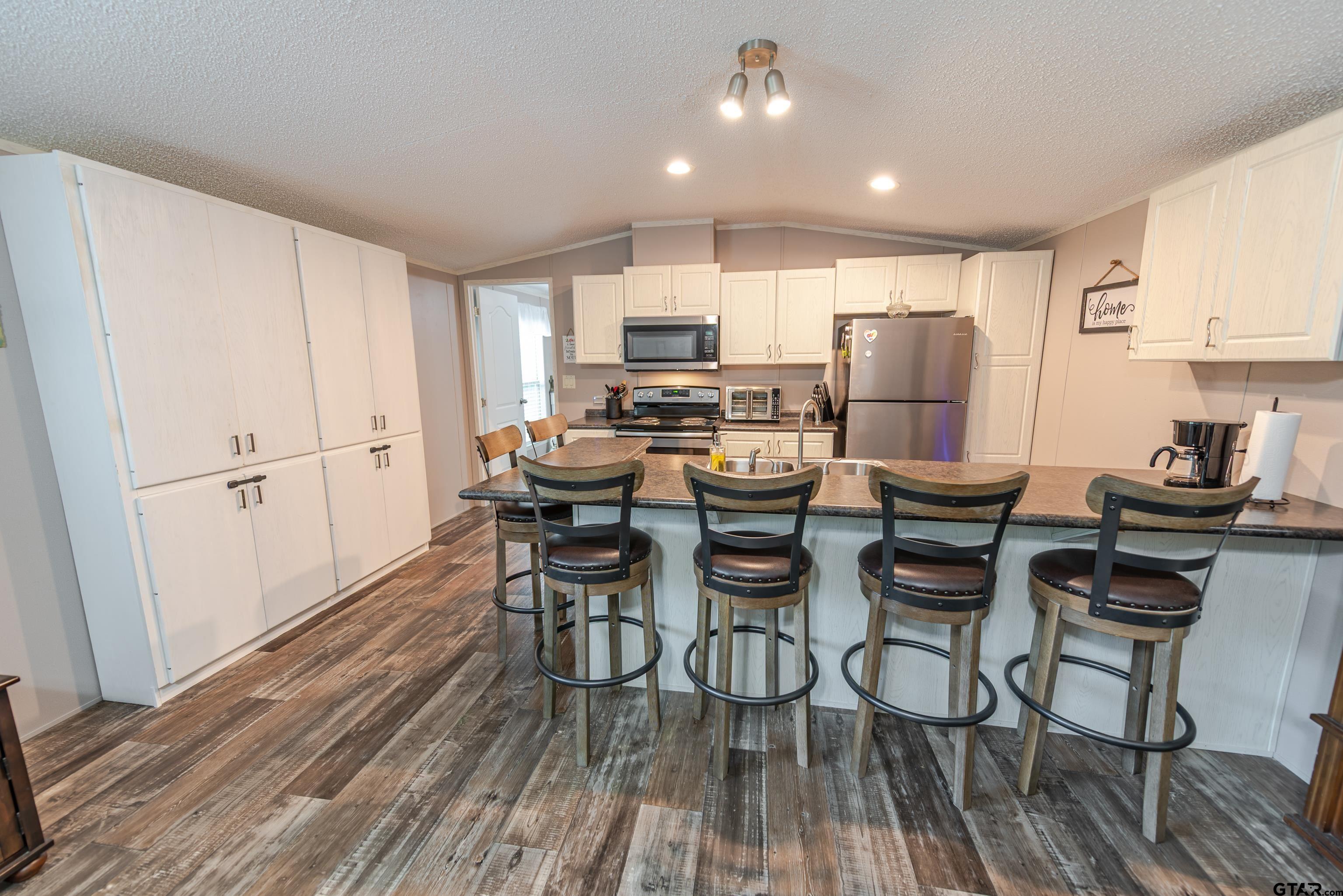 108 Sandy Brown Road Scroggins, TX 75480 - Photo 12 of 17 a view of a dining room with furniture a rug and wooden floor
