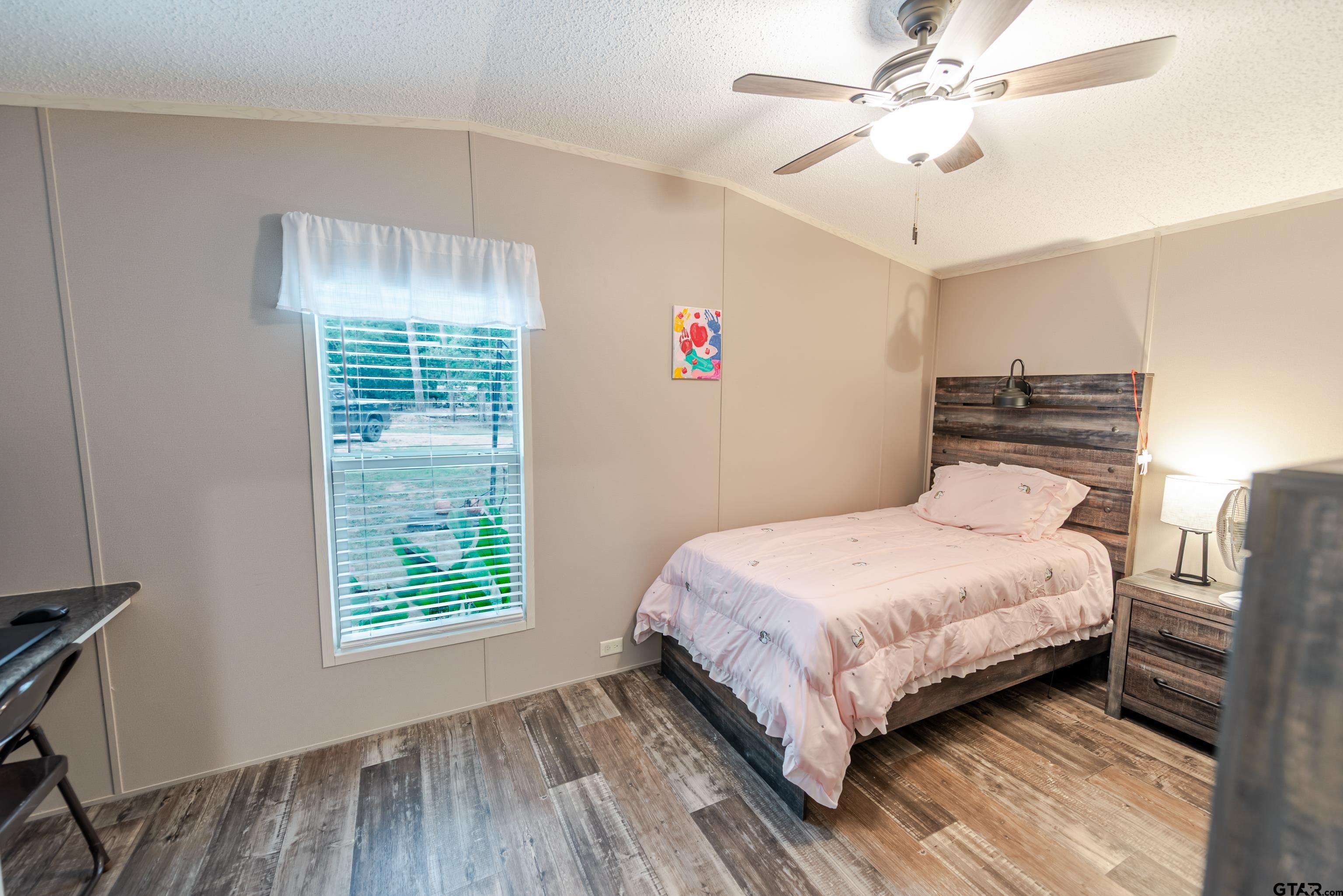 108 Sandy Brown Road Scroggins, TX 75480 - Photo 16 of 17 a bedroom with a bed and a window