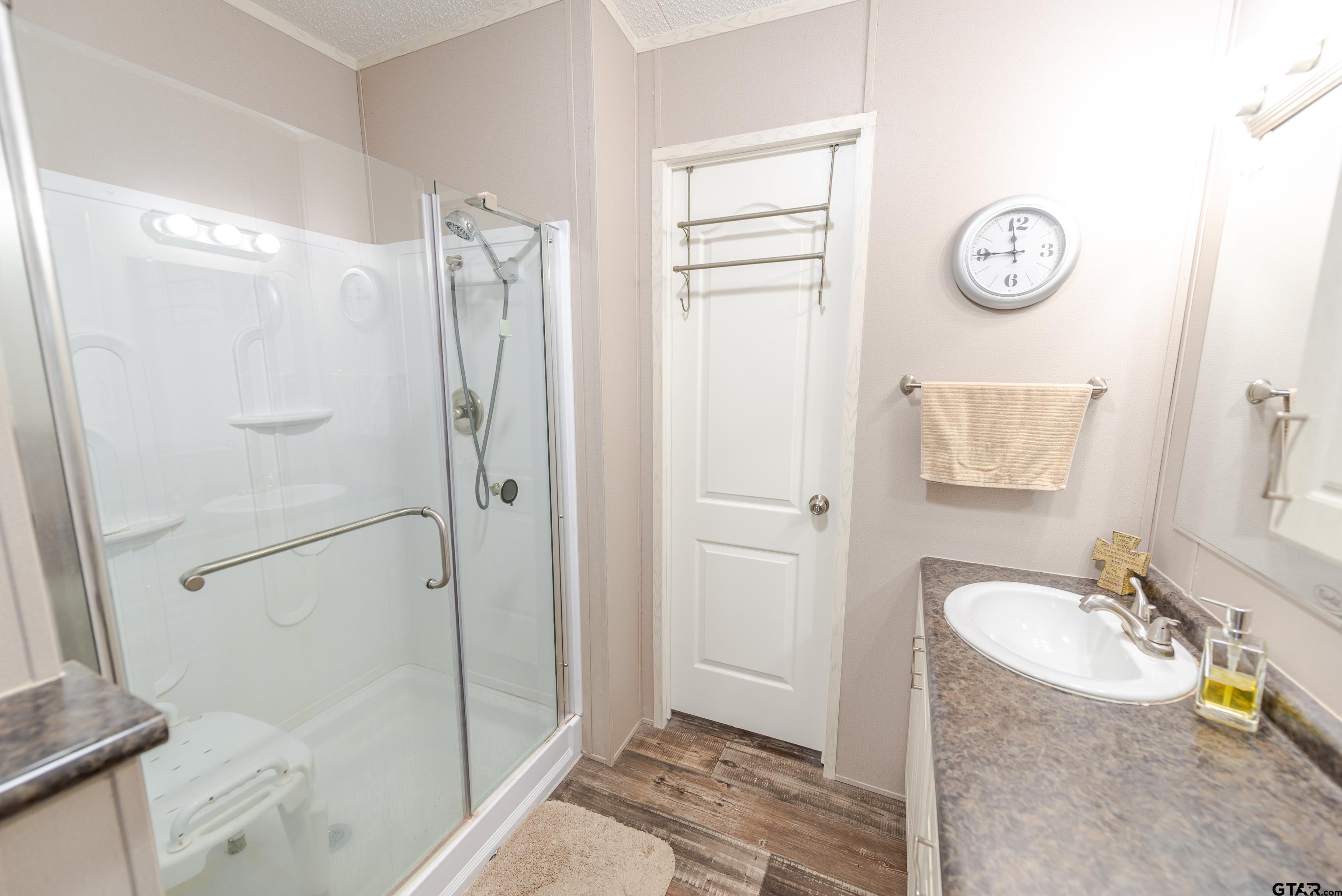 108 Sandy Brown Road Scroggins, TX 75480 - Photo 7 of 17 a bathroom with a granite countertop shower sink and mirror