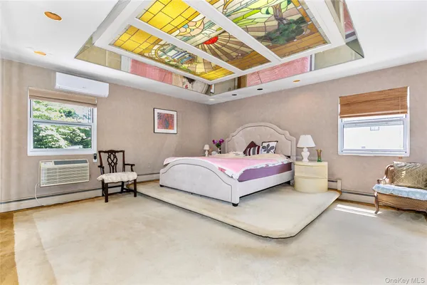 a bedroom with a bed a couch and a window