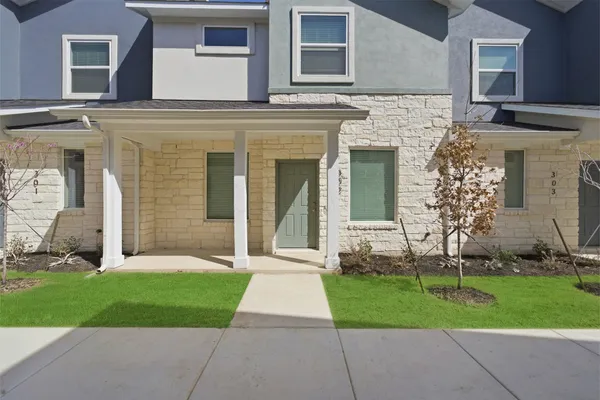 front view of a house with a yard