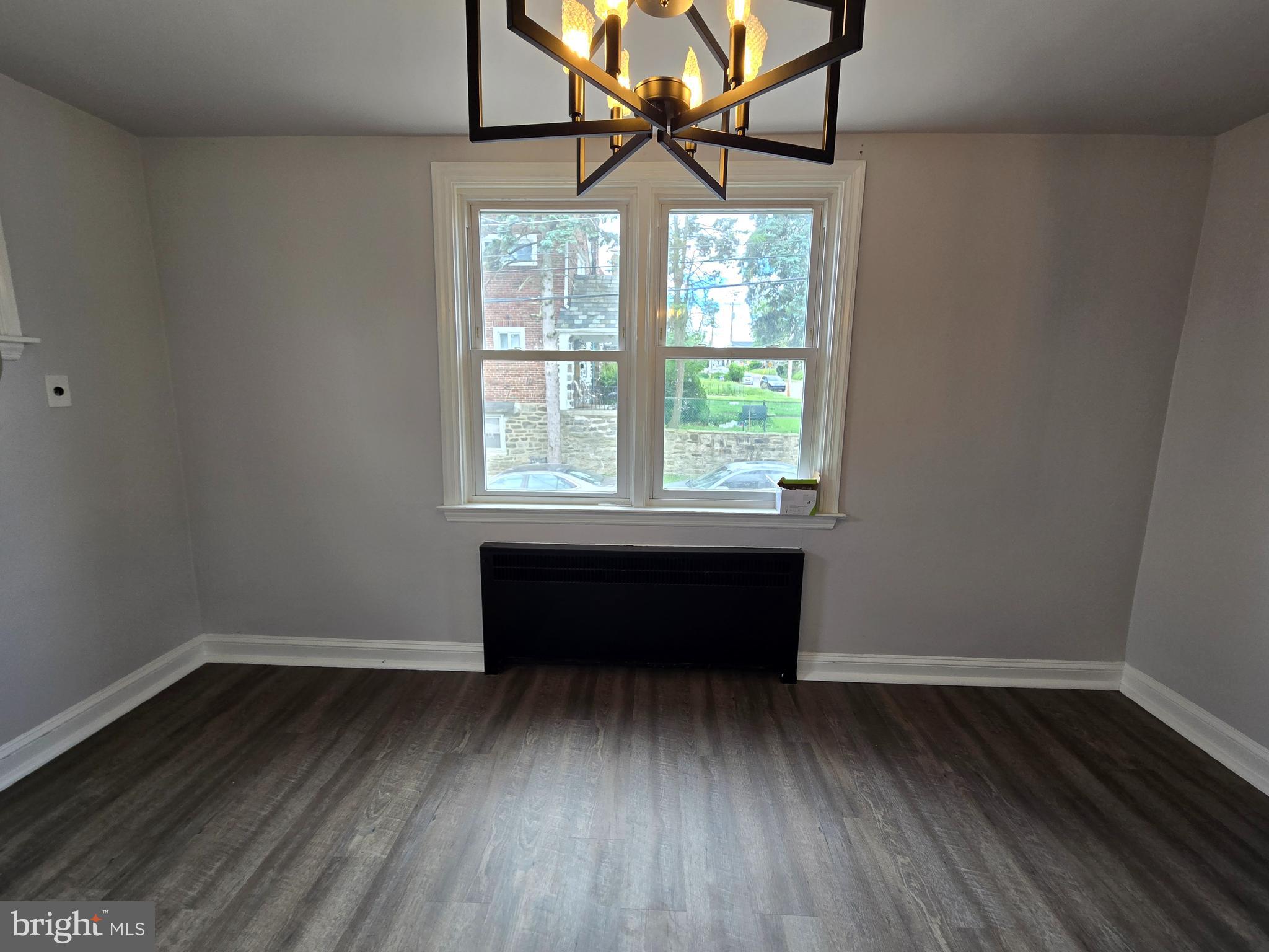 201 St Laurence Road Upper Darby, PA 19082 - Photo 12 of 37 an empty room with wooden floor and windows