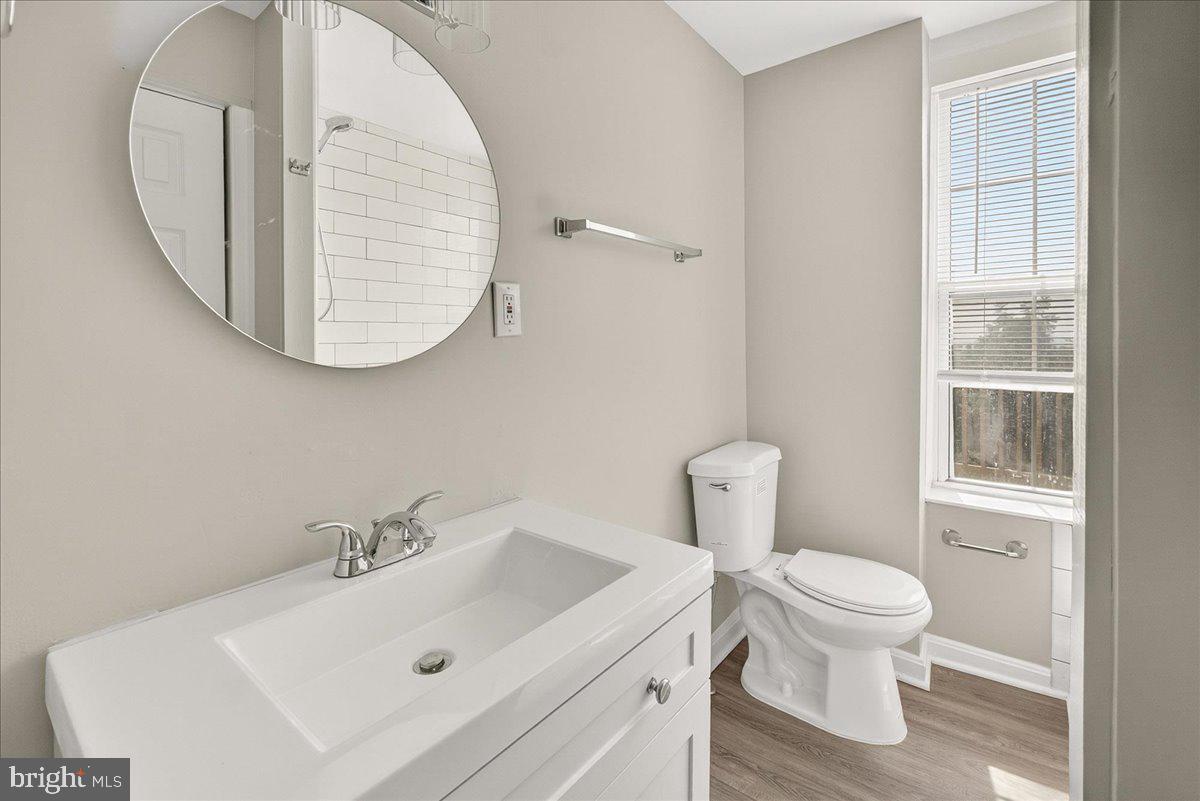 6215 South Clifton Road Braddock Heights, MD 21703 - Photo 11 of 46 a bathroom with a sink a toilet and a mirror