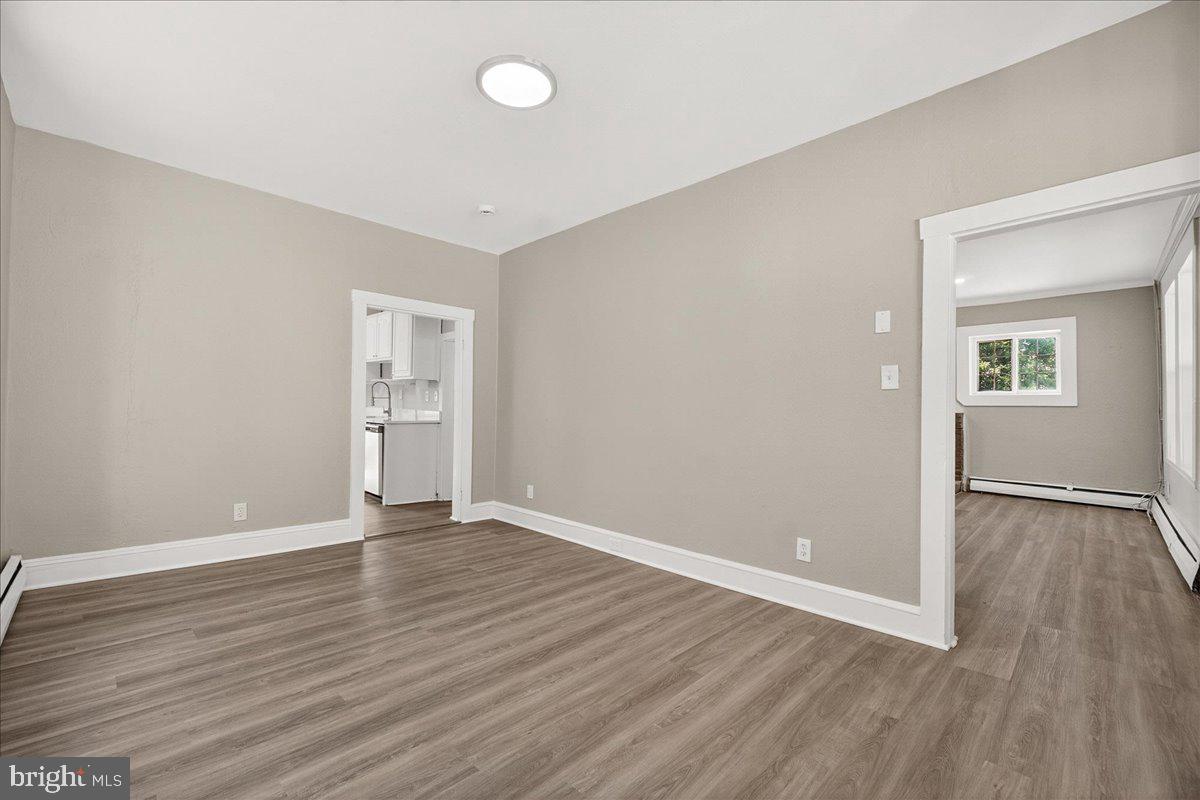 6215 South Clifton Road Braddock Heights, MD 21703 - Photo 14 of 46 a view of an empty room with wooden floor and a window