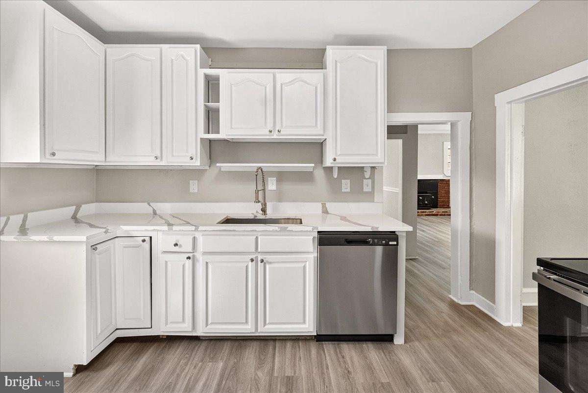 6215 South Clifton Road Braddock Heights, MD 21703 - Photo 17 of 46 a kitchen with stainless steel appliances granite countertop a sink and cabinets with wooden floor