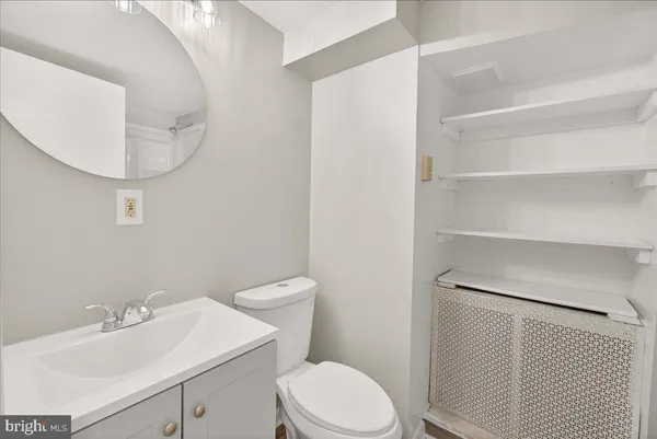 a white toilet sitting next to a bathroom sink