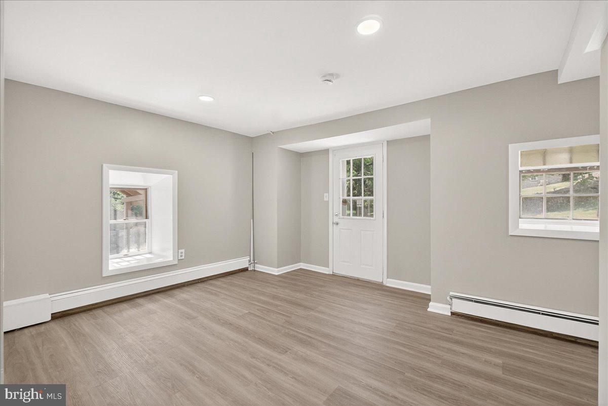 6215 South Clifton Road Braddock Heights, MD 21703 - Photo 31 of 46 an empty room with wooden floor and windows
