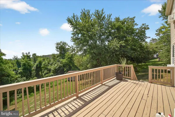 a view of balcony with wooden floor and fence