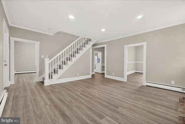 a view of an empty room with wooden floor