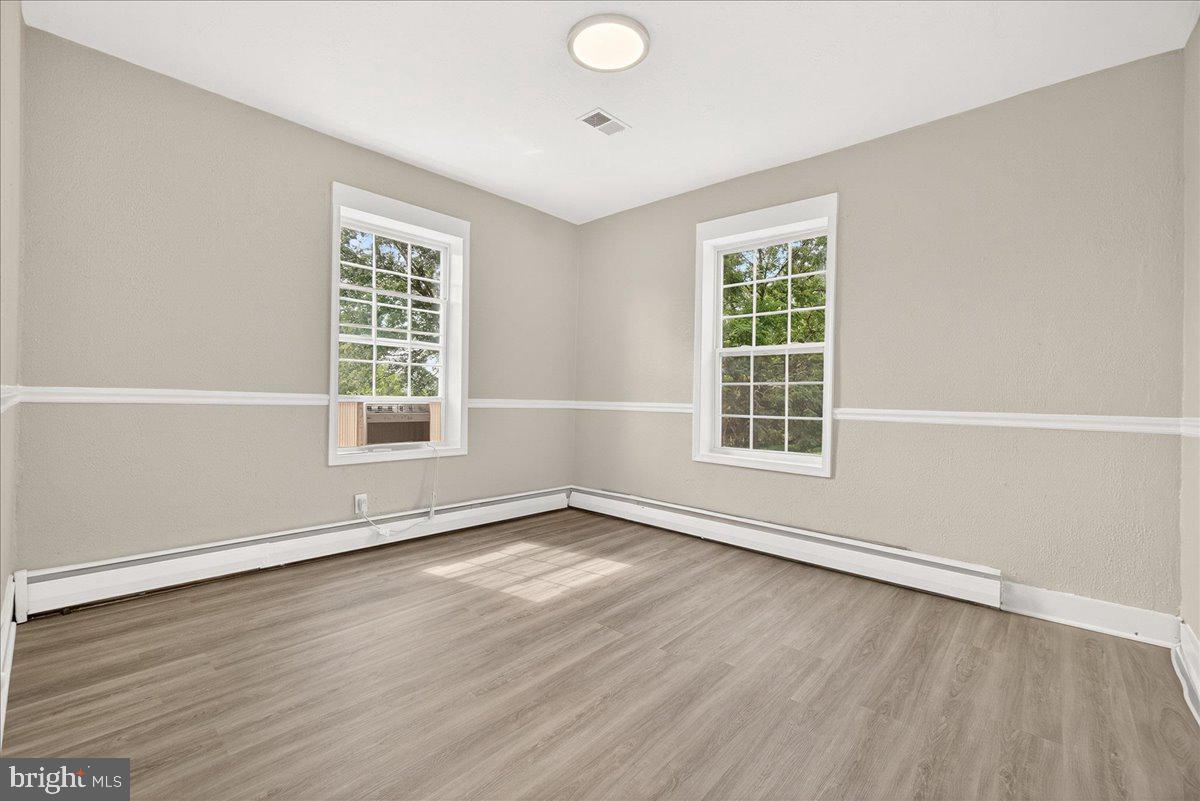 6215 South Clifton Road Braddock Heights, MD 21703 - Photo 8 of 46 an empty room with wooden floor and windows