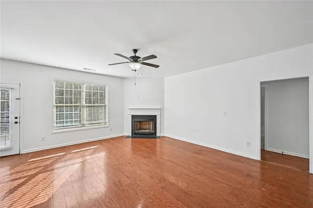 a view of a livingroom with a ceiling fan and window