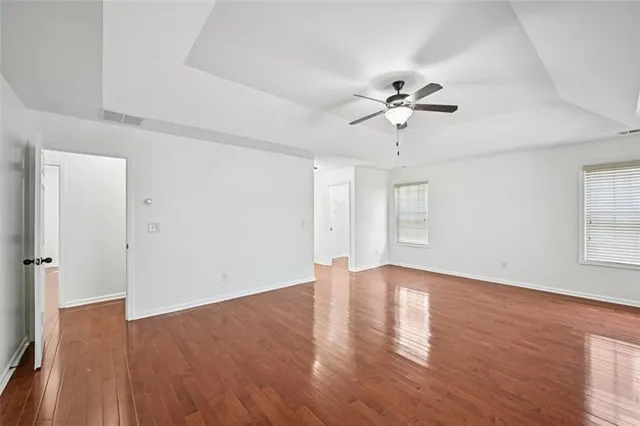 a view of room with wooden floor and tub