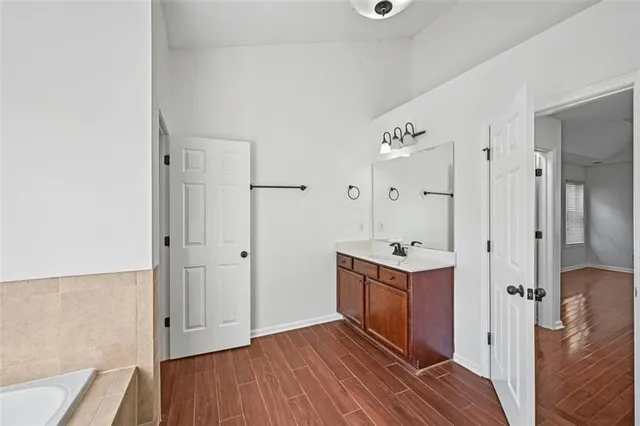 an empty room with a window and ceiling fan