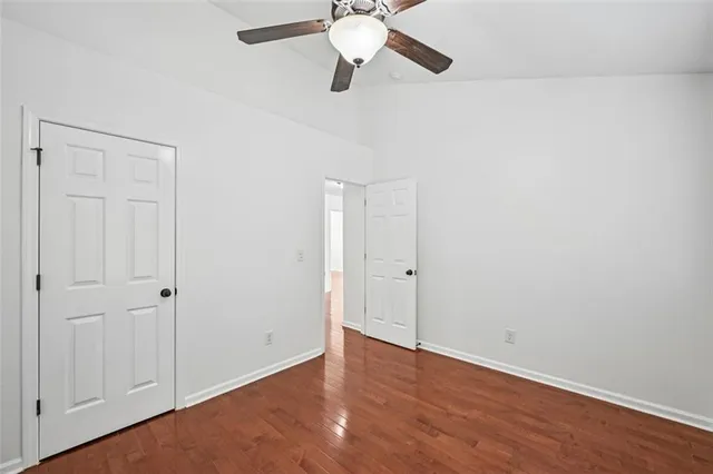 a view of backyard of house with wooden deck and seating space