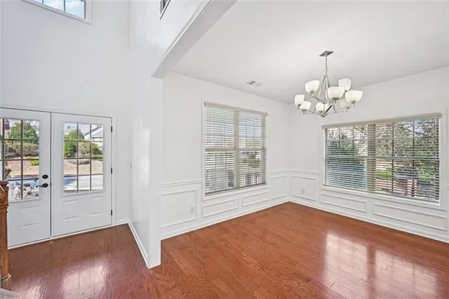 a big room with windows and fireplace
