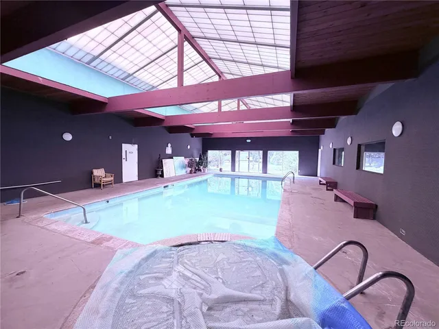 a room with pool table and windows