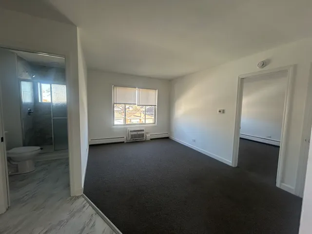 an empty room with windows and entrance