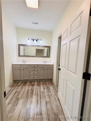 a bathroom with a sink a mirror and a toilet