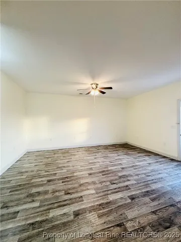 a view of a room with wooden floor
