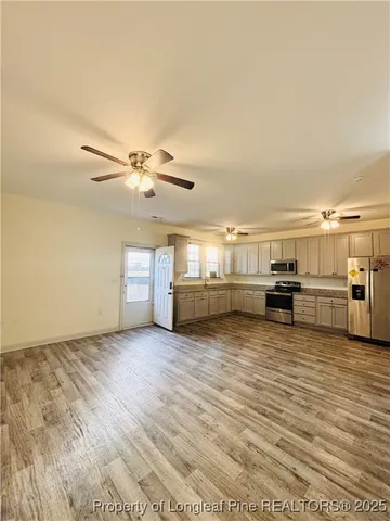 a view of a kitchen with microwave and cabinets