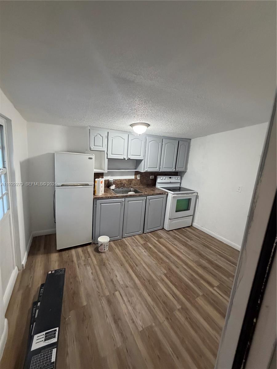 2980 Northwest 79th Street, Unit A Miami, FL 33147 - Photo 3 of 7 a large white bed in a white room