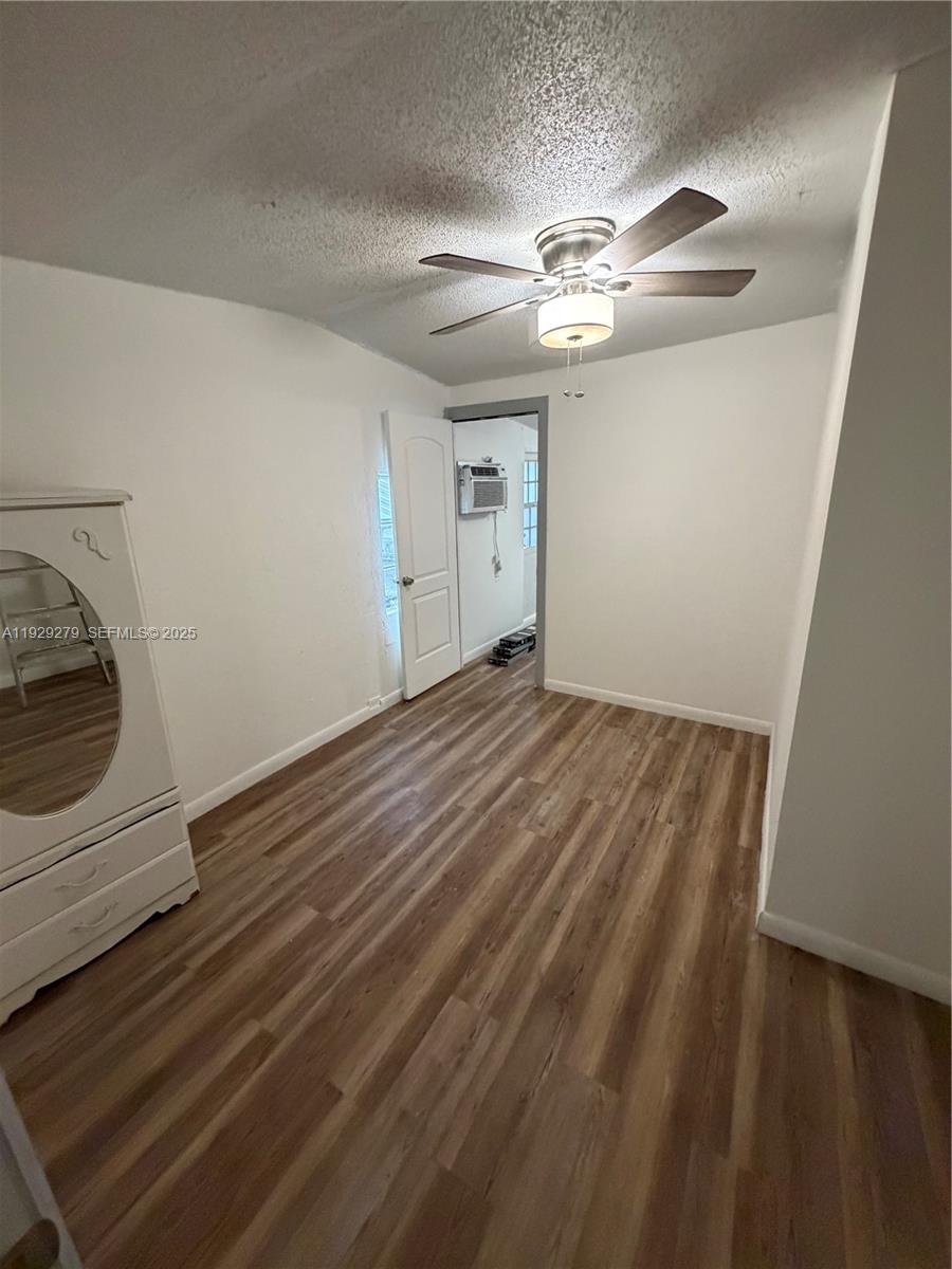 2980 Northwest 79th Street, Unit A Miami, FL 33147 - Photo 5 of 7 a view of a livingroom with a ceiling fan and wooden floor