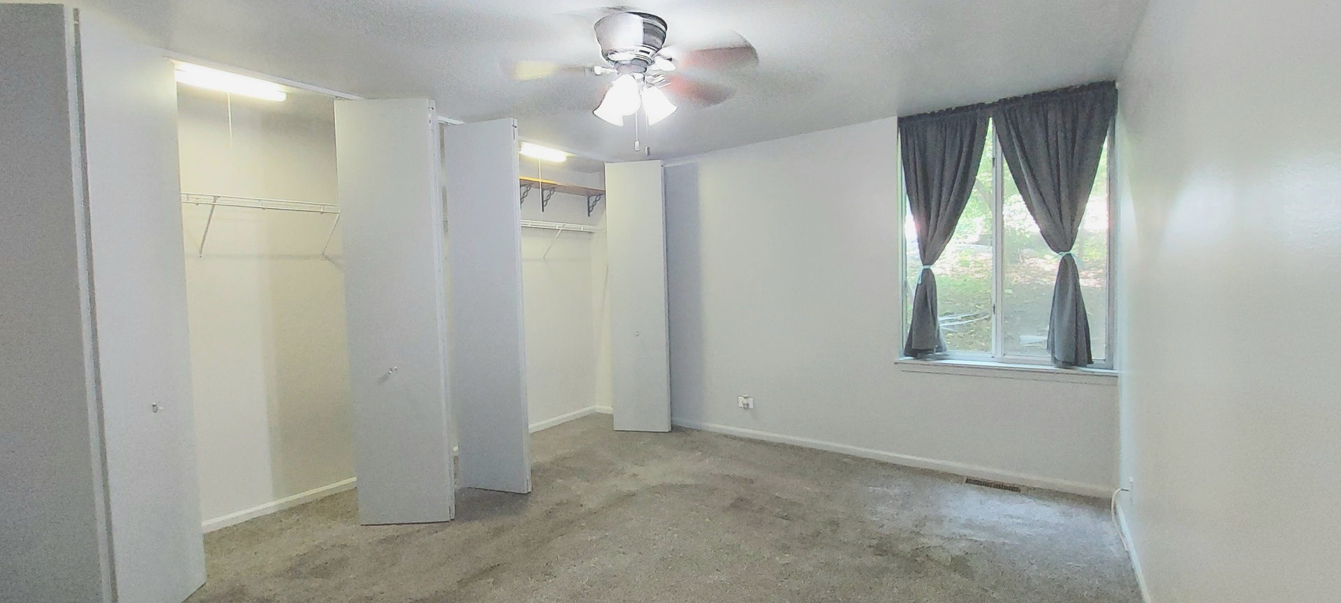 6010 Forest View Road, Unit 1A Lisle, IL 60532 - Photo 15 of 39 an empty room with windows and fan