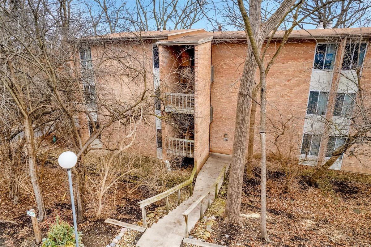 6010 Forest View Road, Unit 1A Lisle, IL 60532 - Photo 2 of 39 a front view of a house with parking space