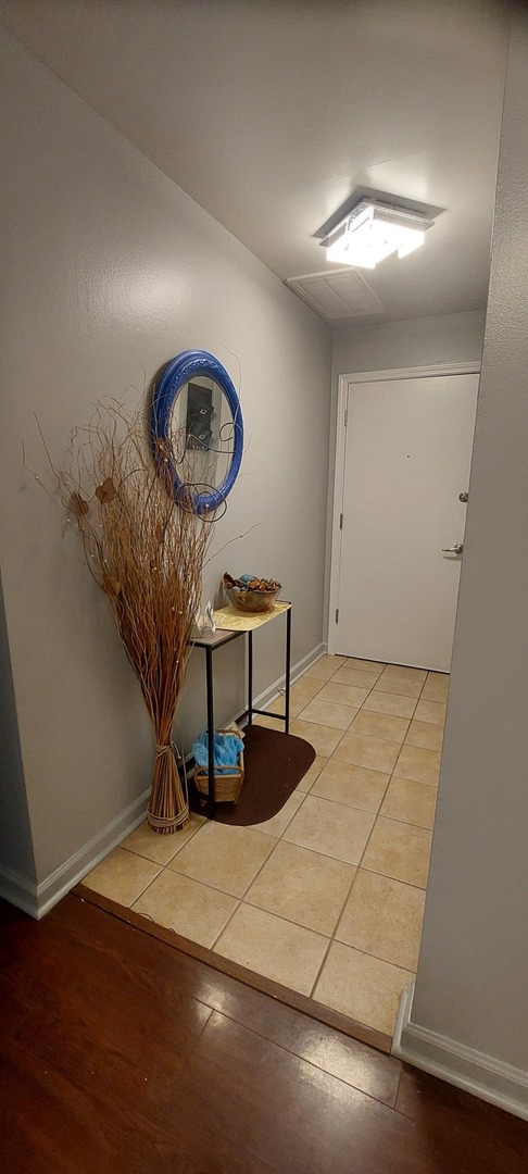 6010 Forest View Road, Unit 1A Lisle, IL 60532 - Photo 21 of 39 a room with a table and a mirror