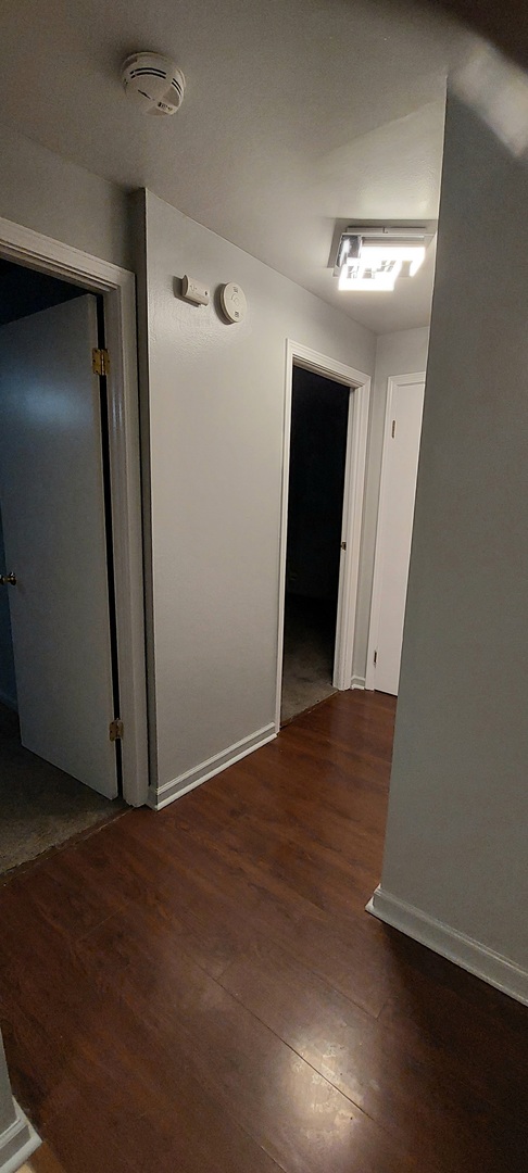 6010 Forest View Road, Unit 1A Lisle, IL 60532 - Photo 22 of 39 an empty room with wooden floor and closet