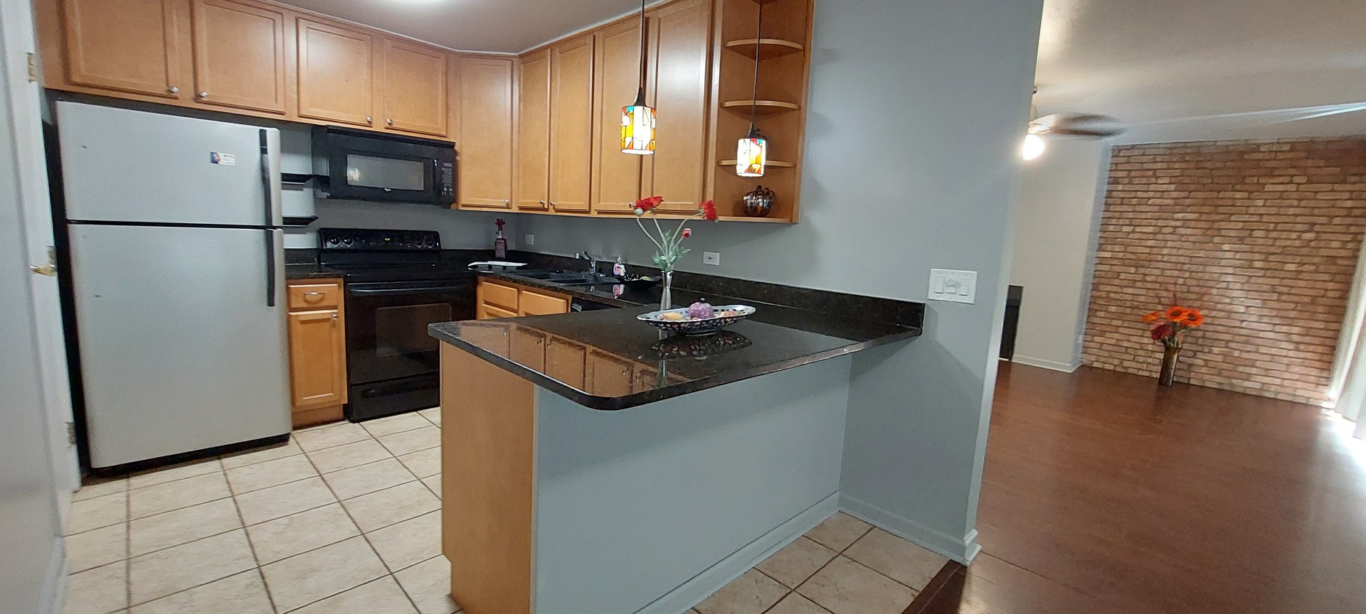 6010 Forest View Road, Unit 1A Lisle, IL 60532 - Photo 5 of 39 a kitchen with stainless steel appliances granite countertop a refrigerator a stove a sink and a microwave
