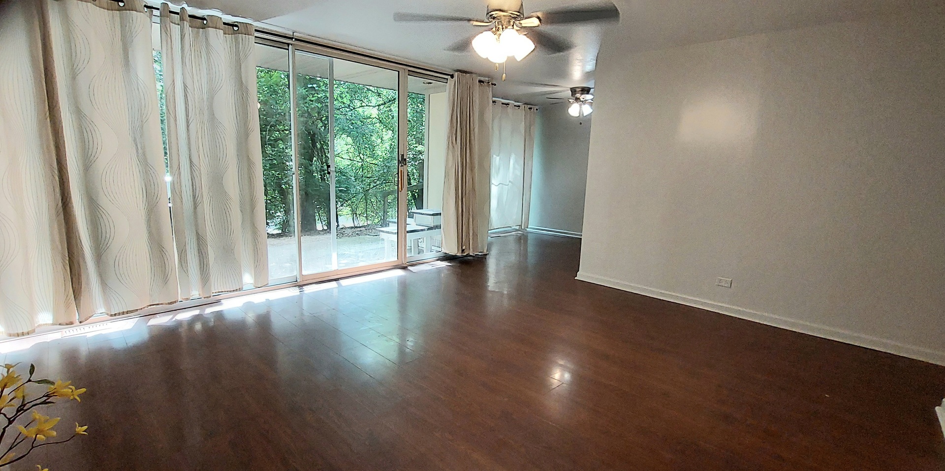 6010 Forest View Road, Unit 1A Lisle, IL 60532 - Photo 8 of 39 an empty room with wooden floor and windows with curtains