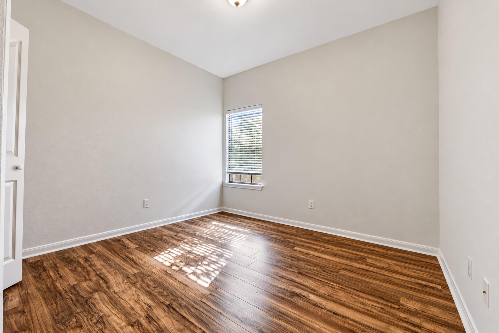 150 Engineers Pass Jarrell, TX 76537 - Photo 25 of 40 Rich wood-look flooring and a tall window bring warmth to this versatile space.