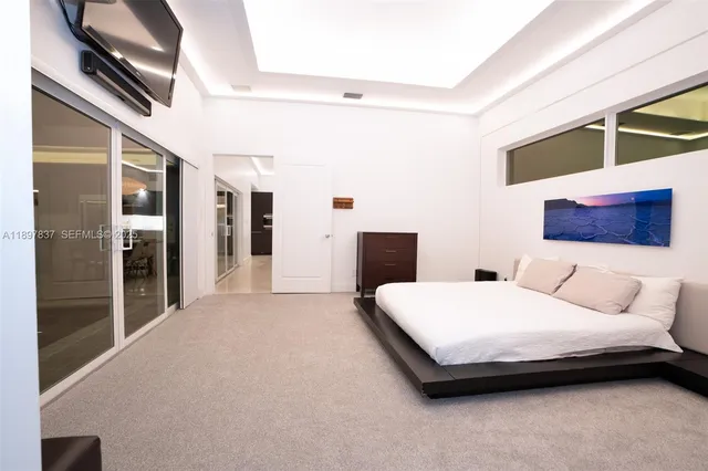 a living room with large window and a flat screen tv