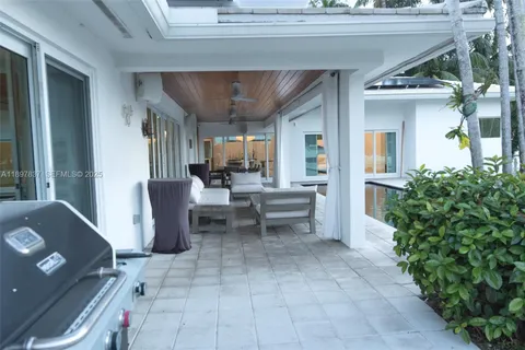 a view of a house with a yard and sitting area