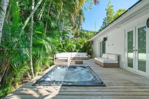 an aerial view of a house with a yard and lake view
