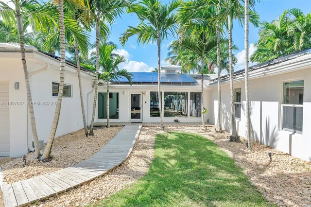 a view of a house with backyard porch and sitting area