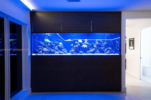 a kitchen with stainless steel appliances a sink and a table