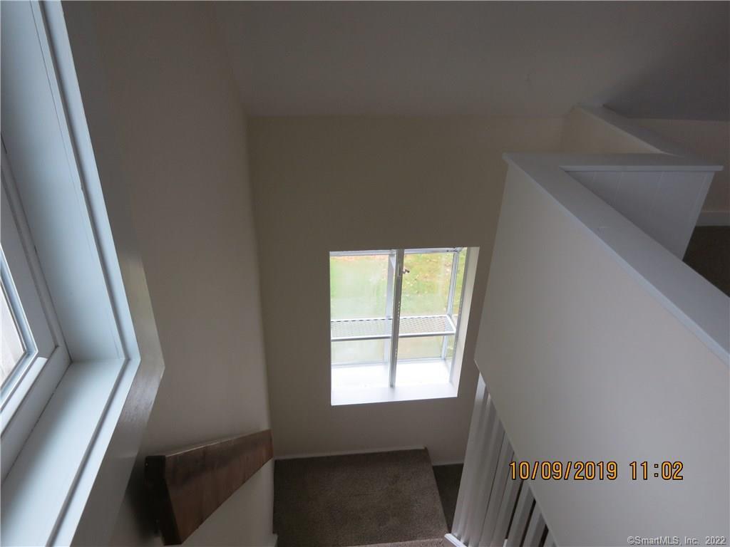 22 Garnet Park Road Madison, CT 06443 - Photo 13 of 18 The staircase features a Greenhouse window that allows for a great deal of light and is a focal point.