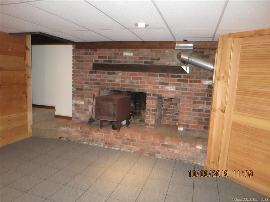 22 Garnet Park Road Madison, CT 06443 - Photo 15 of 18 The family room enjoys a wood stove and carpet.